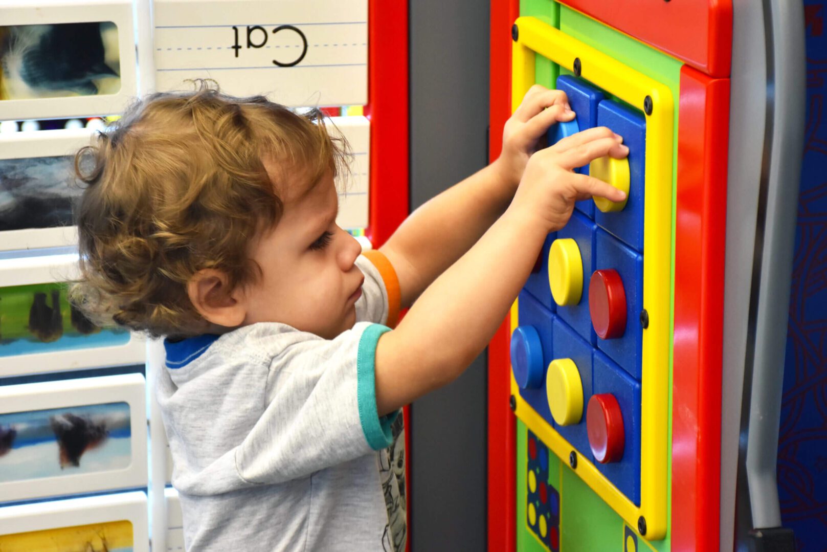 Kid playing with colorful toys